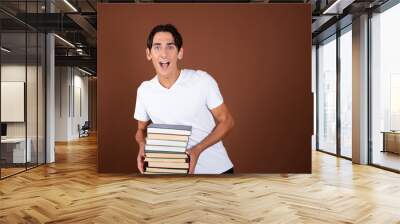 Rest and study at the university. Handsome guy with books. Wall mural