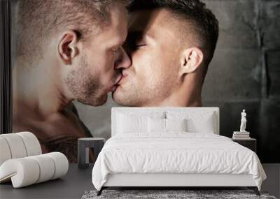 Young attractive couple kissing. Two handsome men. Wall mural