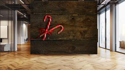 Closeup of two old fashioned candy canes on a rustic wooden back Wall mural