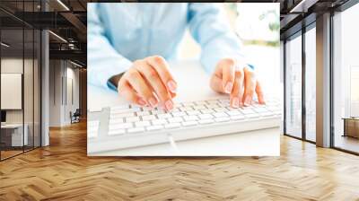 Woman office worker typing on the keyboard Wall mural