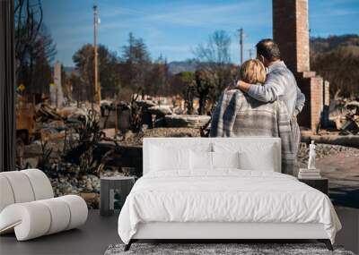 Man and his wife owners, checking burned and ruined of their house and yard after fire, consequences of fire disaster accident. Ruins after fire disaster. Wall mural