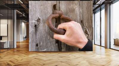 An ancient handmade door bell, A knock at the door, a wooden door Wall mural