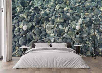 Top view of stones under water on shallow water on a sunny day in flat lay Wall mural