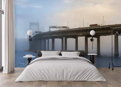 Picturesque view of Throgs Neck Bridge covered with fog in NYC Wall mural