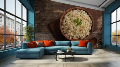 Bowl of cooked Whole grain brown rice  on wooden background overhead view Wall mural