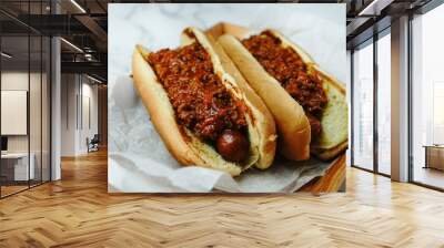 Homemade Chili dogs topped with cheddar cheese, selective focus Wall mural