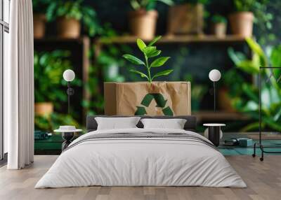 Cardboard box with recycle symbol and a green plant on top, eco-friendly concept Wall mural