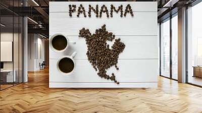 Map of the Panama made of roasted coffee beans laying on white wooden textured background with two cups of coffee. Space for text.  Wall mural