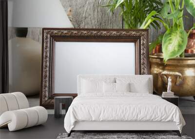 empty brown picture frame on wooden background. Wall mural