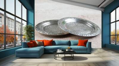 Old metal coasters, small dish on concrete background. Wall mural