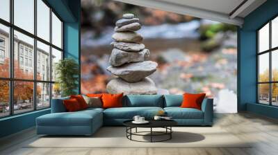 Balanced stones or stone pyramid on the river bank. Wall mural