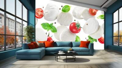 Flying slices of mozzarella cheese with cherry tomatoes, pepper and basil isolated on white background. Wall mural