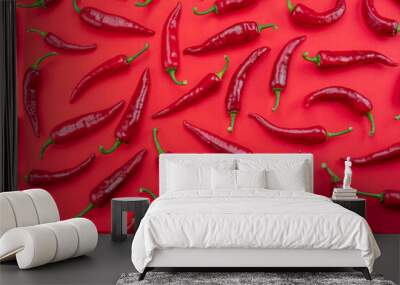 Seamless pattern done of red chilli peppers isolated on red background. Wall mural