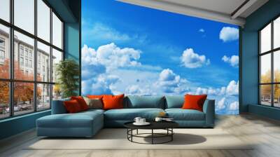 White heap clouds and bright sun in the blue sky. Wall mural