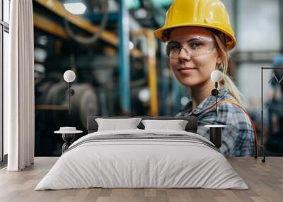 Confident female engineer in industrial setting Wall mural