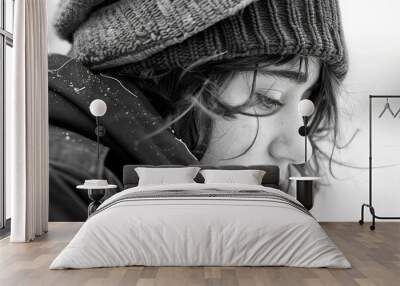 Contemplative young adult in winter attire with a cigarette Wall mural