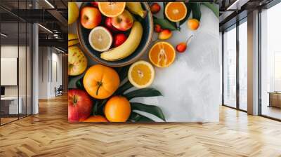 Fresh citrus fruits and apples arranged on a bright background Wall mural