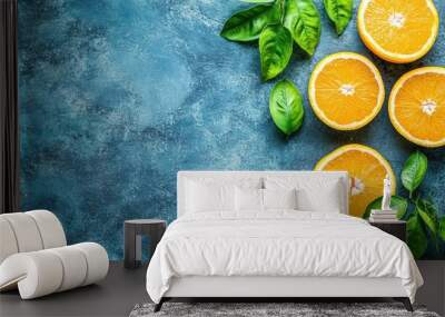 Fresh oranges basil leaves on blue textured background Wall mural