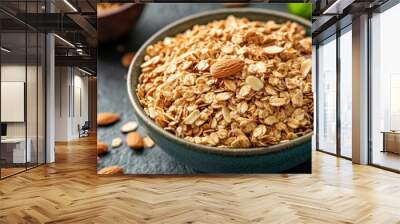 Healthy almond granola in bowl on dark background Wall mural