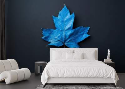 Vibrant blue leaf on a dark background for artistic contrast Wall mural