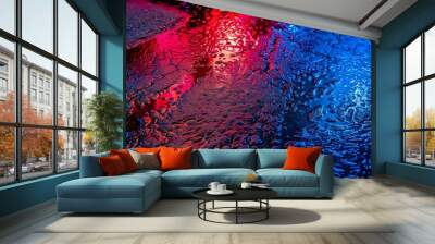 Vibrant night city reflection on wet asphalt road Wall mural