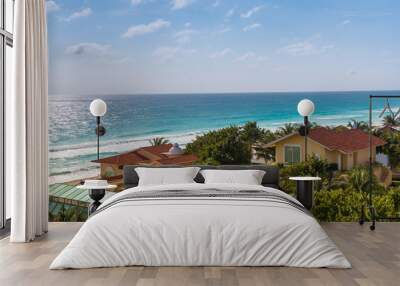 Caribbean tropical style houses on sea shore. Cancun, Mexico Wall mural