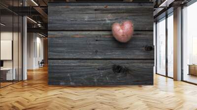 Heart shaped red potato on a gray wooden vintage table in rustic style, valentine day, wooden background, country style Wall mural