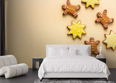 Christmas yellow background with happy man-shaped gingerbreads and stars with frosting Wall mural