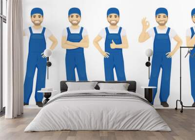 Man in blue overalls set with different gestures isolated Wall mural