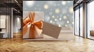 Gift box wrapped with craft paper and bow on neutral background with boke. Holiday concept. Wall mural