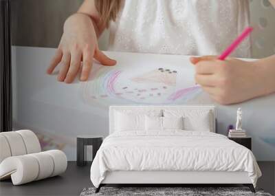 Close-up of a child's hands coloring a drawing with bright pencils. Young girl engaging in colorful artistic drawing and coloring activity using pencils. Enhancing creativity. Imagination Wall mural