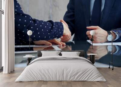 Professional handshake between two professionals and applauds at a corporate meeting with reflection on table over a business meeting. Business people concept Wall mural