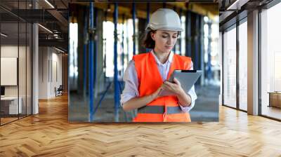 Construction concept of Engineer or Architect working at Construction Site. A woman with a tablet at a construction site. Bureau of Architecture Wall mural