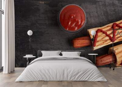 two French hot dogs on a dark wooden table Wall mural