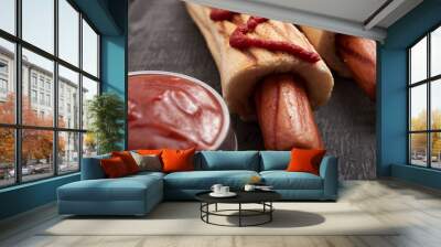 two French hot dogs on a dark wooden table Wall mural