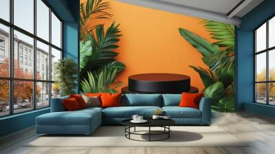 A sleek, black matte round podium framed by lush tropical leaves, set against a bold orange background for a high-contrast and modern look. Wall mural