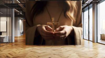 A young woman holds a cross in her hands and prays intently in a Christian church, AI generation Wall mural