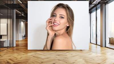 Beautiful smiling woman with naked shoulder isolated on white. Sensual beauty female model face with white teeth close up. Natural beauty woman. Portrait of young woman. Wall mural