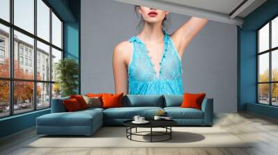 Beautiful young elegant girl in sexy blue dress. Portrait on gray background. Fashionable attire, gamur and luxury. Wall mural