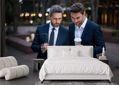 Business men with takeaway coffee and laptop outdoor were strategic in their planning. Business men were effective communicators. Business men team using laptop outdoor. Businessmen looking laptop. Wall mural