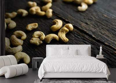 Cashew nuts scattered on the wooden vintage table. Cashew nut is a healthy vegetarian protein nutritious food. Wall mural