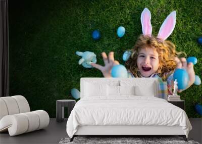 Child hunt egg in garden on Easter day. Easter banner, mockup copy space, poster flyer header for website template. Top view funny kids face. Wall mural