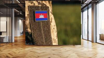 Close up millitary woman or man shoulder arm sleeve with Cambodia flag patch. Cambodia troops army, soldier camouflage uniform. Armed Forces, empty copy space for text
 Wall mural