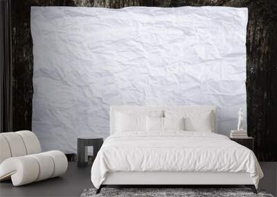 Crumpled white sheet of paper on a dark wooden background Wall mural