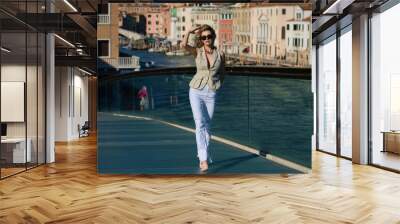 Europe travel vacation. Woman on famous travel destination in Venice. Elegant lady wearing fashion dress on holidays in Venice. Luxury travel in Venice, Italy. Woman tourist. Wall mural