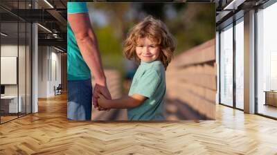 Father and son holding hand in hand. Weekend activity happy family lifestyle concept. Wall mural