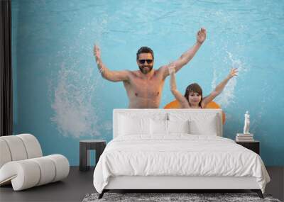 Father and son in swimming pool on summer vacation. Child with dad playing in pool. Dad and kid in pool at summer day. Leisure and swimming at holidays. Father have fun with the son in the pool. Wall mural