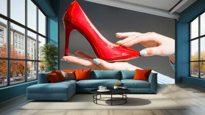 footwear or shoe red color leather on female hand Wall mural