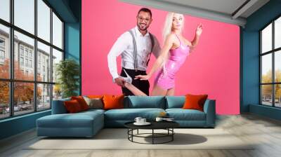 Funny girl and man in dolls style isolated on pink. Wall mural