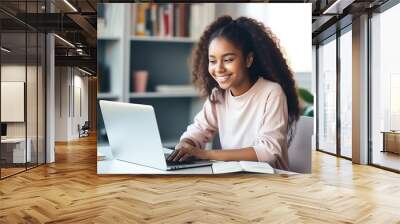 Happy African American teen student elearning at home on pc, writing notes. Smiling teenage girl using laptop watching webinar, hybrid learning english online virtual class, sitting at home table Wall mural